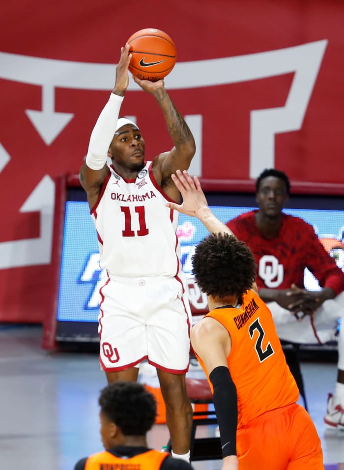 De'Vion Harmon (11) shoots over potential No. 1 overall 2021 NBA Draft Pick Cade Cunningham (2) on February 27, 2021 at the Lloyd Noble Center in Norman, Oklahoma.